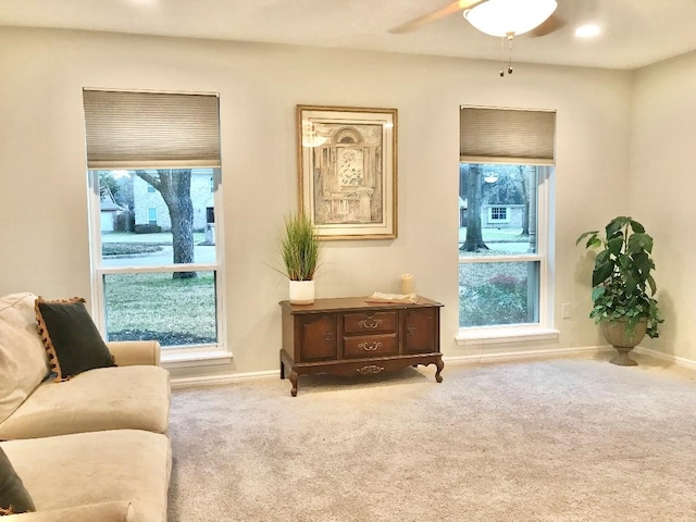 sitting room featuring ceiling fan and carpet flooring