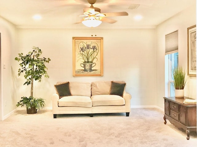 carpeted living room featuring crown molding and ceiling fan