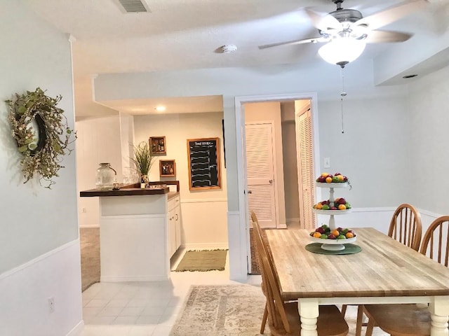 tiled dining space featuring ceiling fan