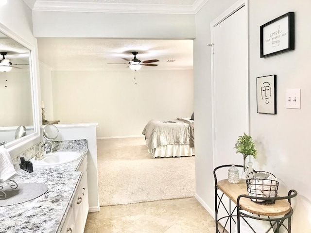 bathroom featuring ornamental molding, vanity, and ceiling fan