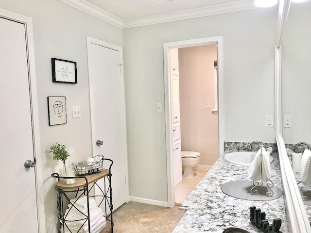 bathroom with vanity, crown molding, and toilet