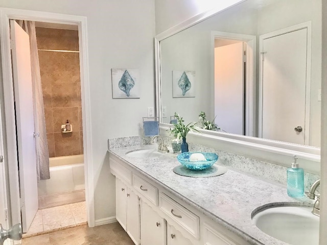 bathroom featuring vanity, tile patterned floors, and tiled shower / bath