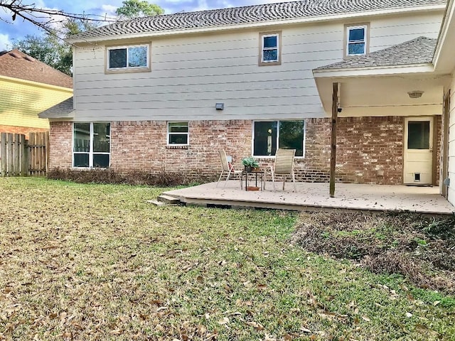 rear view of property with a deck and a lawn