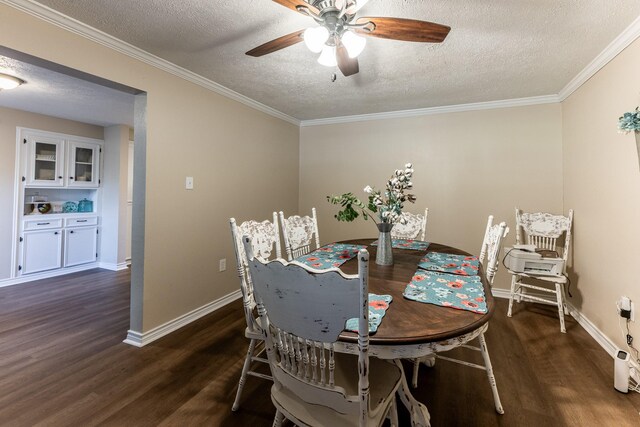 dining space featuring crown molding, dark hardwood / wood-style flooring, and a textured ceiling