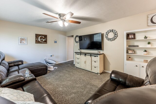 carpeted living room featuring a textured ceiling and ceiling fan