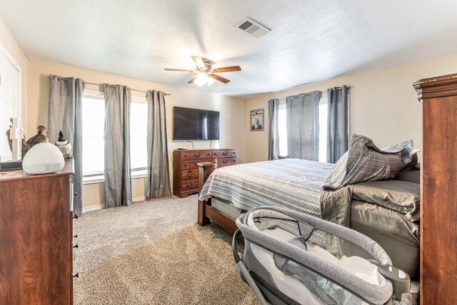 bedroom with light colored carpet and ceiling fan