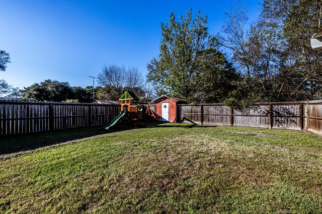 view of yard with a playground and a shed