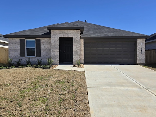 view of front facade featuring a garage and a front lawn