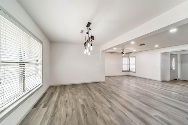 unfurnished living room featuring ceiling fan and light hardwood / wood-style floors