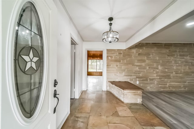 mudroom with a notable chandelier and ornamental molding