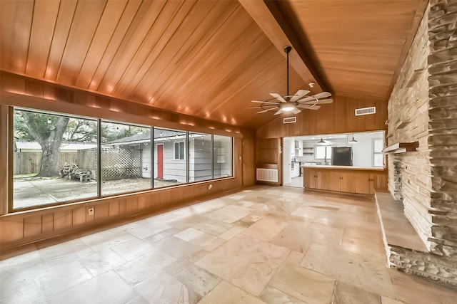 unfurnished sunroom with lofted ceiling with beams, wooden ceiling, and ceiling fan