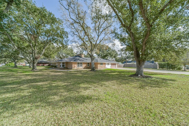 ranch-style home with a front lawn