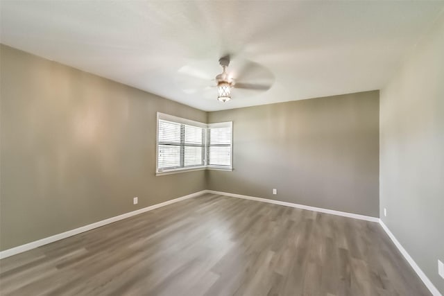 spare room featuring hardwood / wood-style flooring and ceiling fan