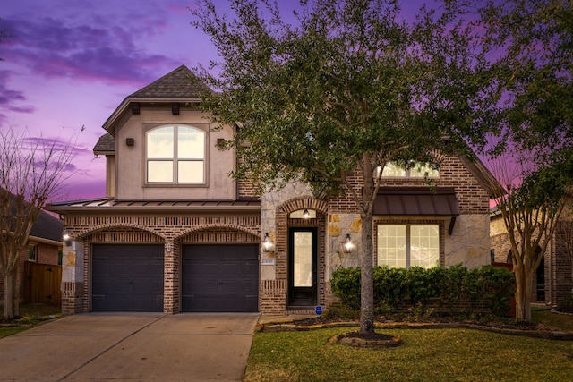 view of front of property featuring a garage and a yard