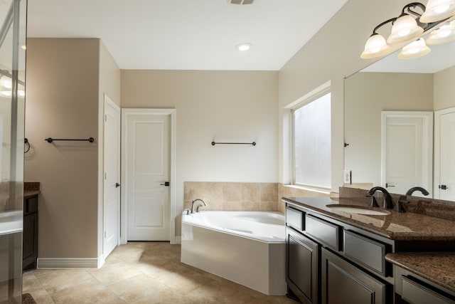 bathroom with vanity, a washtub, tile patterned floors, and a chandelier