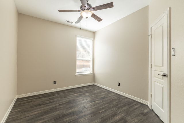 spare room with dark wood-type flooring and ceiling fan