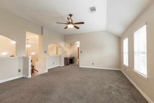 unfurnished living room featuring vaulted ceiling, ceiling fan, and carpet