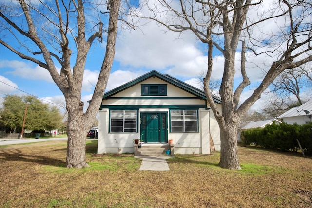 bungalow-style home featuring a front yard