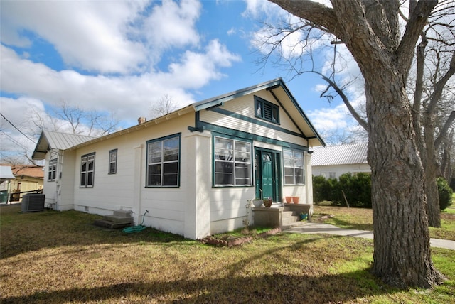 view of property exterior featuring central AC unit and a yard