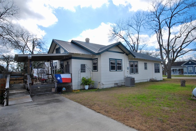 view of home's exterior with a carport, a yard, and central AC