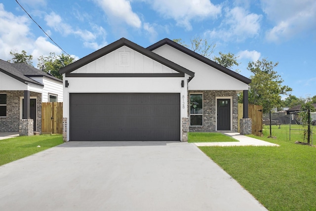 craftsman-style house featuring a garage and a front yard