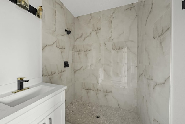 bathroom with vanity and tiled shower