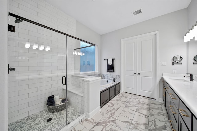 bathroom featuring vanity and independent shower and bath