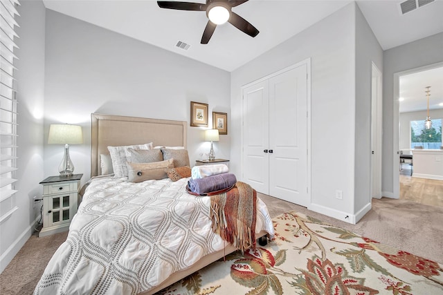 carpeted bedroom with a closet and ceiling fan