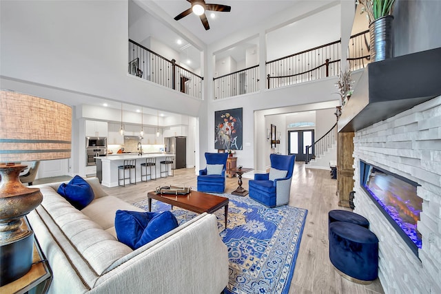 living room featuring ceiling fan and light hardwood / wood-style floors