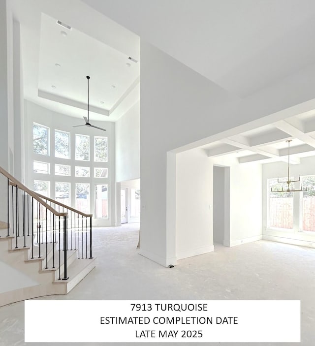7913 Turquoise Ln, Houston, TX 77055 - stairway featuring plenty of natural light, a ceiling fan, a chandelier, a high ceiling, and baseboards