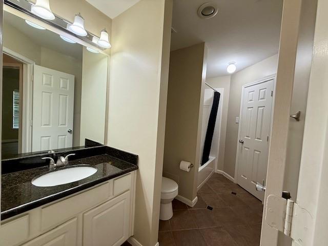 full bathroom featuring shower / bath combo, toilet, tile patterned floors, and vanity