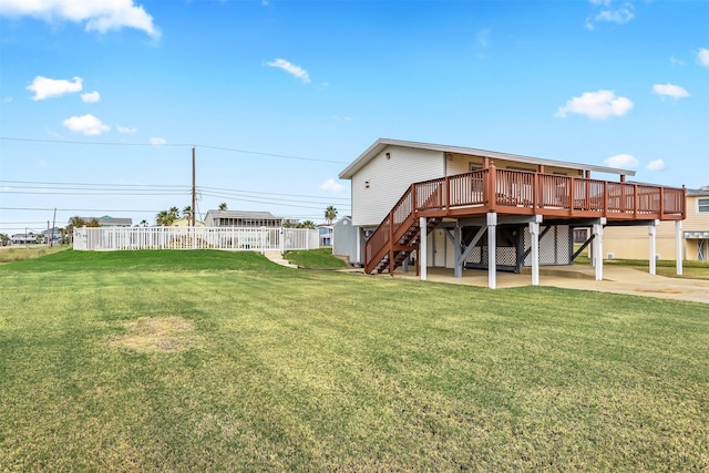 back of house with a yard and a deck