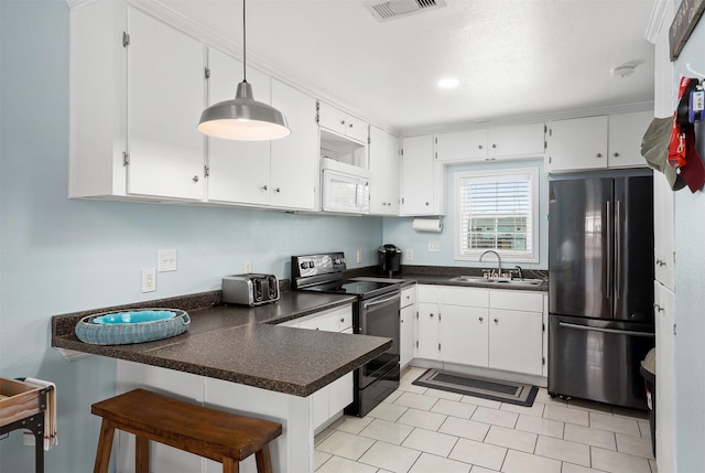 kitchen featuring sink, stainless steel appliances, hanging light fixtures, and white cabinets