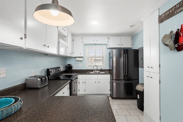 kitchen with black electric range oven, sink, white cabinetry, ornamental molding, and stainless steel fridge