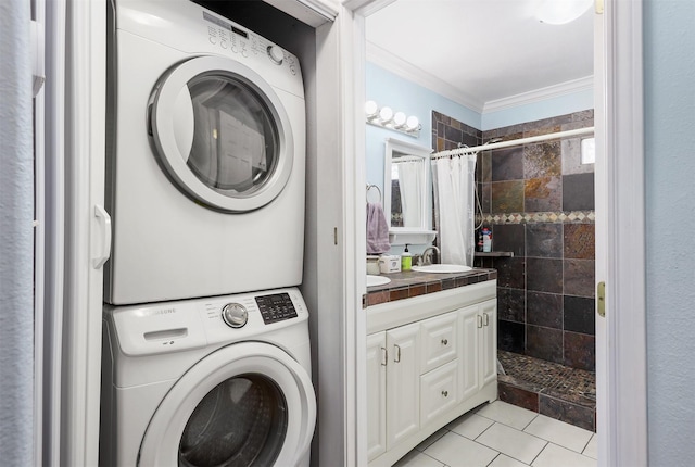 laundry room with crown molding, stacked washer and dryer, sink, and light tile patterned floors