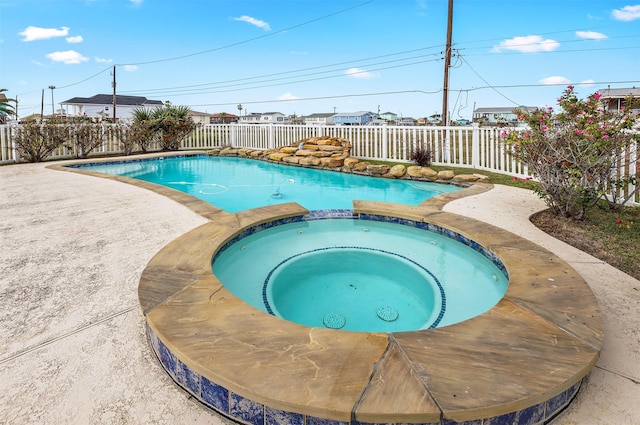 view of swimming pool featuring an in ground hot tub