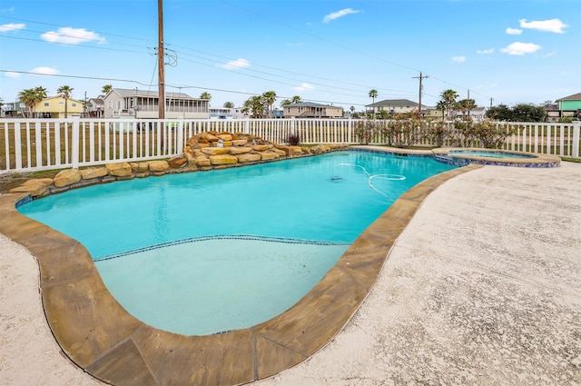 view of pool with an in ground hot tub and a patio area