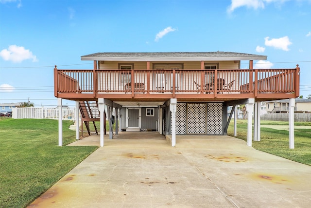 view of front facade with a carport, a deck, and a front lawn