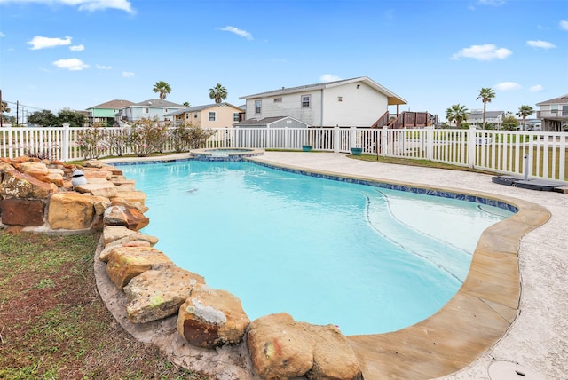 view of pool with an in ground hot tub