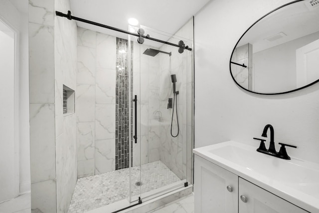 bathroom featuring vanity and a shower with door