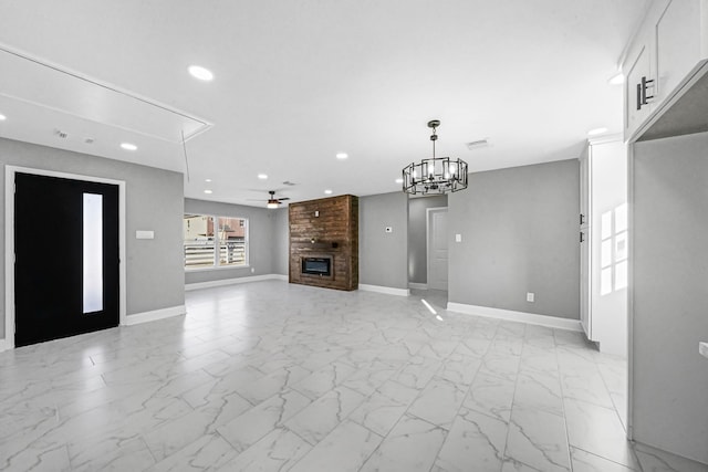 unfurnished living room featuring ceiling fan and a fireplace