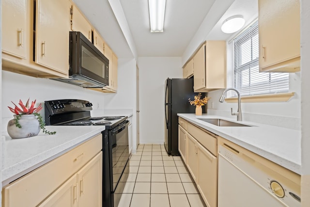 kitchen featuring light tile patterned flooring, sink, and black appliances