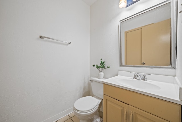 bathroom with vanity, tile patterned floors, and toilet