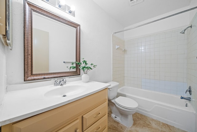 full bathroom featuring tiled shower / bath, vanity, toilet, and tile patterned floors