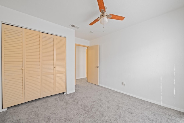 unfurnished bedroom featuring ceiling fan, carpet floors, and a closet