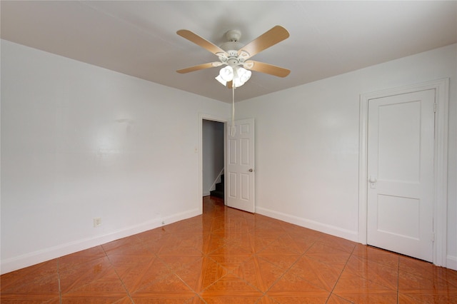 empty room featuring parquet flooring and ceiling fan