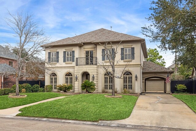 view of front of property with a garage, a balcony, and a front lawn