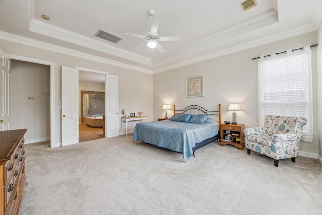 carpeted bedroom with ceiling fan, ensuite bath, ornamental molding, and a raised ceiling