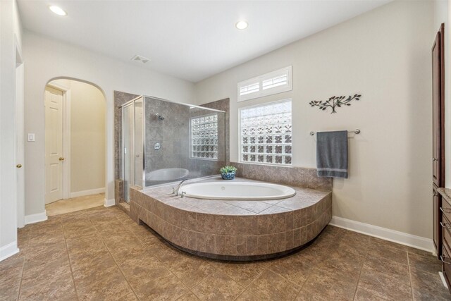 bathroom with separate shower and tub