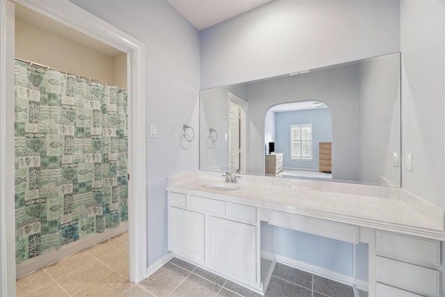 bathroom with a shower with curtain, vanity, and tile patterned flooring